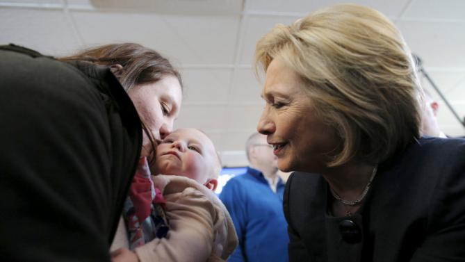 U.S. Democratic presidential candidate Hillary Clinton greets a mother and her baby in the audience at a campaign stop at the Family Fun Center in Adel, Iowa January 27, 2016. REUTERS/Brian Snyder