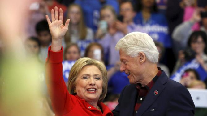 U.S. Democratic presidential candidate Hillary Clinton (L) waves after being introduced onto the stage by husband, former U.S. President Bill Clinton, during a campaign rally at Washington High School in Cedar Rapids, Iowa January 30, 2016.  REUTERS/Adrees Latif