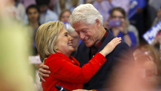 U.S. Democratic presidential candidate Hillary Clinton (L) embraces husband former U.S. President Bill Clinton after being introduced onto the stage during a campaign rally at Washington High School in Cedar Rapids, Iowa January 30, 2016.  REUTERS/Adrees Latif