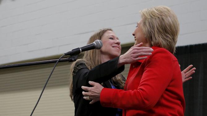 U.S. Democratic presidential candidate Hillary Clinton gets a hug from her daughter Chelsea (L) during an off-schedule stop at the "I'll Make Me a World in Iowa Celebration Day" in Des Moines, Iowa January 30, 2016. REUTERS/Brian Snyder