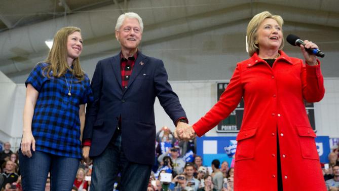Democratic presidential candidate Hillary Clinton, right, accompanied by former President Bill Clinton and their daughter Chelsea Clinton, arrives to speak at a rally at Washington High School in Cedar Rapids, Iowa, Saturday, Jan. 30, 2016. (AP Photo/Andrew Harnik)