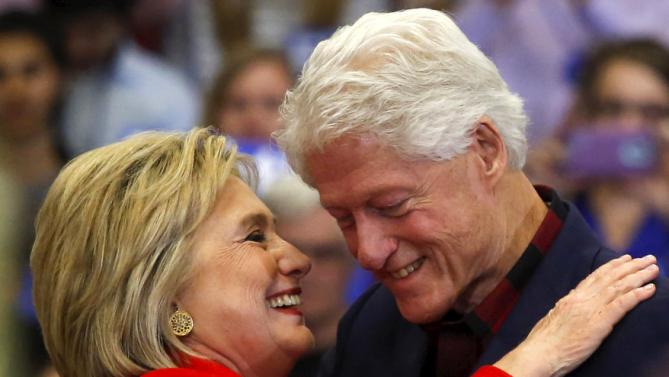 U.S. Democratic presidential candidate Hillary Clinton (L) embraces husband former U.S. President Bill Clinton after he introduced her onto the stage during a campaign rally at Washington High School in Cedar Rapids, Iowa January 30, 2016.  REUTERS/Adrees Latif