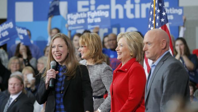 Chelsea Clinton speaks as her mother U.S. Democratic presidential candidate Hillary Clinton stands with Gabby Giffords and her husband Mark Kelly (R) during a "Get Out to Caucus" rally at Iowa State University in Ames, Iowa January 30, 2016.  The New York Times's editorial board endorsed Democrat Hillary Clinton and Republican John Kasich as they seek to become their parties' nominees in the U.S. presidential election, calling Clinton one of the most "deeply qualified presidential candidates in modern history." REUTERS/Brian Snyder