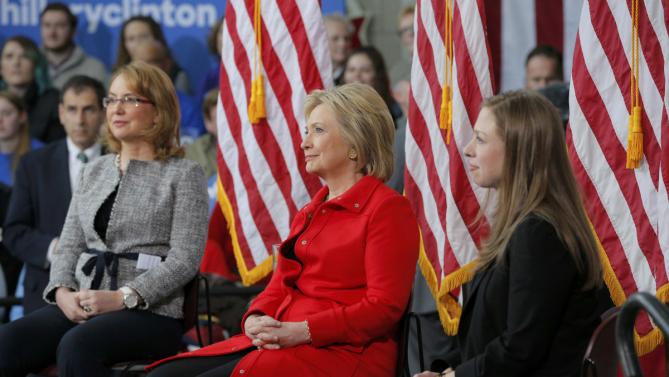 Chelsea Clinton sits with her mother U.S. Democratic presidential candidate Hillary Clinton and Gabby Giffords during a "Get Out to Caucus" rally at Iowa State University in Ames, Iowa January 30, 2016.  The New York Times's editorial board endorsed Democrat Hillary Clinton and Republican John Kasich as they seek to become their parties' nominees in the U.S. presidential election, calling Clinton one of the most "deeply qualified presidential candidates in modern history." REUTERS/Brian Snyder