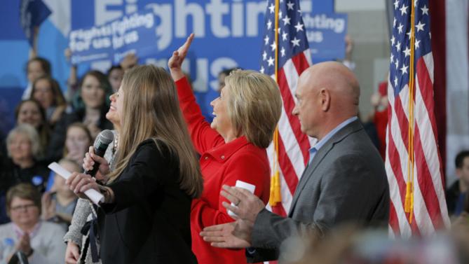 U.S. Democratic presidential candidate Hillary Clinton waves to the crowd as she arrives with her daughter Chelsea Clinton, Gabby Giffords and her husband Mark Kelly (R) during a "Get Out to Caucus" rally at Iowa State University in Ames, Iowa January 30, 2016.  The New York Times's editorial board endorsed Democrat Hillary Clinton and Republican John Kasich as they seek to become their parties' nominees in the U.S. presidential election, calling Clinton one of the most "deeply qualified presidential candidates in modern history." REUTERS/Brian Snyder
