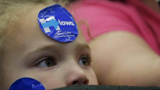 Seven-year-old Alexis Griffiths listens as U.S. Democratic presidential candidate Hillary Clinton speaks during a "Get Out to Caucus" rally in Cedar Rapids, Iowa January 30, 2016.  REUTERS/Brian Snyder