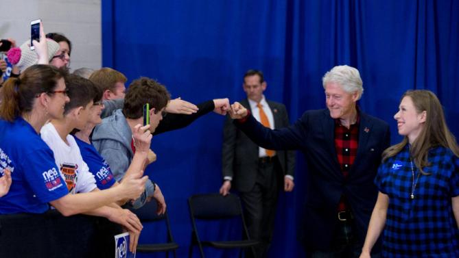 Former President Bill Clinton gives a member of the audience a fist bump as he and his daughter Chelsea Clinton, arrive to speak at a rally for Democratic presidential candidate Hillary Clinton at Washington High School in Cedar Rapids, Iowa, Saturday, Jan. 30, 2016. (AP Photo/Andrew Harnik)