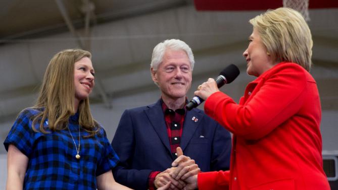 Democratic presidential candidate Hillary Clinton, right, accompanied by former President Bill Clinton and their daughter Chelsea Clinton, speaks at a rally at Washington High School in Cedar Rapids, Iowa, Saturday, Jan. 30, 2016. (AP Photo/Andrew Harnik)