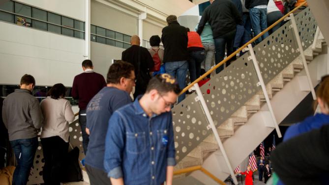 Visitors line the staircase as Democratic presidential candidate Hillary Clinton, bottom right, speaks at a rally at Iowa State University in Ames, Iowa Saturday, Jan. 30, 2016.  (AP Photo/Andrew Harnik)