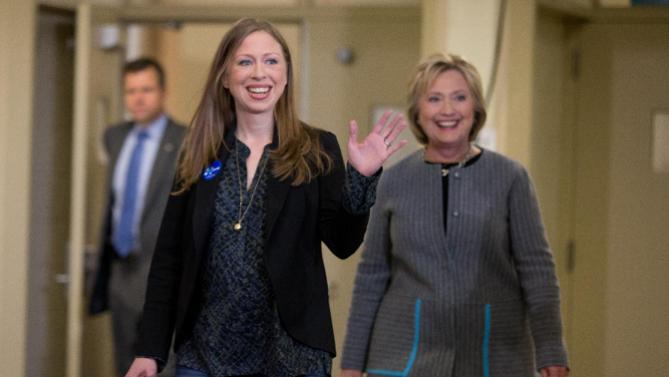 Democratic presidential candidate Hillary Clinton, accompanied by her daughter Chelsea Clinton, arrives for a rally at Abraham Lincoln High School in Council Bluffs, Iowa, Sunday, Jan. 31, 2016. (AP Photo/Andrew Harnik)