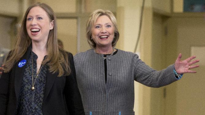 Democratic presidential candidate Hillary Clinton, accompanied by her daughter Chelsea Clinton, reacts to applause as she arrives for a rally at Abraham Lincoln High School in Council Bluffs, Iowa, Sunday, Jan. 31, 2016. (AP Photo/Andrew Harnik)
