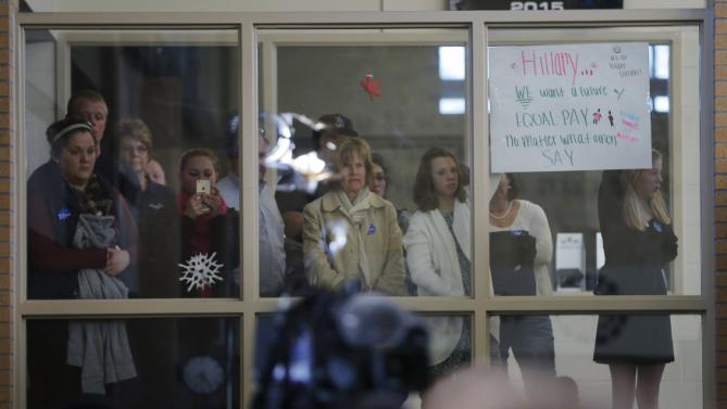 Audience members behind a glass partition listen to U.S. Democratic presidential candidate Hillary Clinton speak during a "Get Out to Caucus" rally in Council Bluffs, Iowa January 31, 2016, one day before Iowa's first-in-the-nation caucus.    REUTERS/Brian Snyder