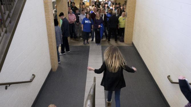 Members of the audience line the hallway to listen to Democratic presidential candidate Hillary Clinton, accompanied by her daughter Chelsea Clinton, speak at a rally at Abraham Lincoln High School in Council Bluffs, Iowa, Sunday, Jan. 31, 2016. (AP Photo/Andrew Harnik)