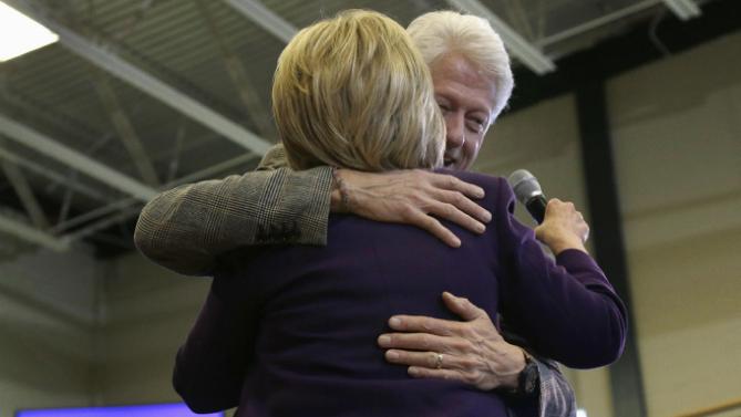 Former President Bill Clinton hugs his wife, Democratic presidential candidate Hillary Clinton after introducing her at a campaign event, Tuesday, Feb. 2, 2016, in Nashua, N.H. (AP Photo/Elise Amendola)