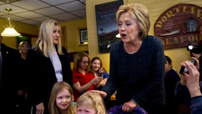 Ella Hamel, 4, of Concord, N.H., cries as she and her sister Ava Hamel, 7, are greeted by Democratic presidential candidate Hillary Clinton during a campaign stop at Belmont Hall in Manchester, N.H., Saturday, Feb. 6, 2016. Her father Steve Hamel says that Ella likes Clinton, supporting her in activities at her school, and was likely feeling "a little overwhelmed." (AP Photo/Jacquelyn Martin)