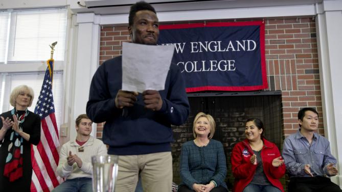 Democratic presidential candidate Hillary Clinton, background center, smiles as she is introduced at a student town hall at New England College in Henniker, N.H., Saturday, Feb. 6, 2016. (AP Photo/Jacquelyn Martin)