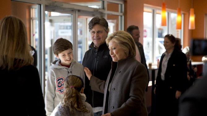 Democratic presidential candidate Hillary Clinton meets a family, Sunday, Feb. 7, 2016, at a Dunkin' Donuts in Manchester, N.H. (AP Photo/Matt Rourke)