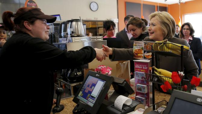 U.S. Democratic presidential candidate Hillary Clinton places an order during a stop at a Dunkin' Donuts in Manchester, New Hampshire February 7, 2016.  REUTERS/Brian Snyder