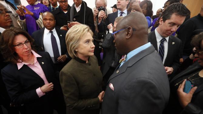 Democratic presidential candidate Hillary Clinton speaks with an audience member at the House Of Prayer Missionary Baptist Church, Sunday, Feb. 7, 2016 in Flint, Mich. (AP Photo/Paul Sancya)
