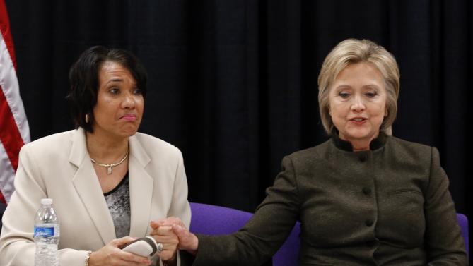 Democratic presidential candidate Hillary Clinton holds the hand of Flint Mayor Karen Weaver during a meeting with officials at the House Of Prayer Missionary Baptist Church, Sunday, Feb. 7, 2016 in Flint, Mich. (AP Photo/Paul Sancya)