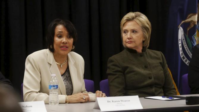 Democratic presidential candidate Hillary Clinton (R) meets with Flint Mayor Karen Weaver and local officials after speaking at a church in Flint, Michigan February 7, 2016.   REUTERS/Rebecca Cook