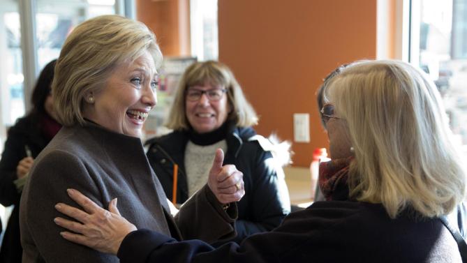 Democratic presidential candidate Hillary Clinton meets with customers Sunday, Feb. 7, 2016, at a Dunkin' Donuts in Manchester, N.H. (AP Photo/Matt Rourke)