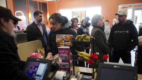 Democratic presidential candidate Hillary Clinton, second from right, meets with customers Sunday, Feb. 7, 2016, at a Dunkin' Donuts in Manchester, N.H. (AP Photo/Matt Rourke)