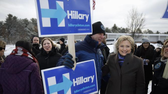 Democratic presidential candidate Hillary Clinton, right, campaigns with her daughter Chelsea Clinton, second from left, outside a polling place during the first-in-the-nation presidential primary, Tuesday, Feb. 9, 2016, in Nashua, N.H. (AP Photo/Matt Rourke)