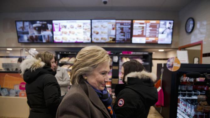 Democratic presidential candidate Hillary Clinton stops at Dunkin' Donuts with her daughter Chelsea Clinton, left, as she campaigns during the first-in-the-nation presidential primary, Tuesday, Feb. 9, 2016, in Nashua, N.H. (AP Photo/Matt Rourke)
