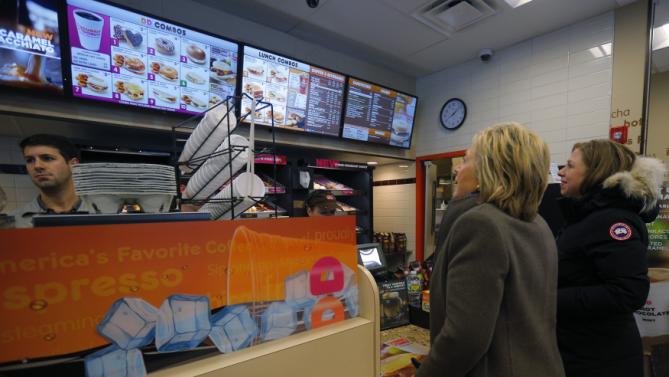 U.S. Democratic presidential candidate Hillary Clinton, and her daughter Chelsea (R), place an order at a Dunkin Donuts in Nashua, New Hampshire February 9, 2016, the day of New Hampshire's first-in-the-nation primary. REUTERS/Brian Snyder