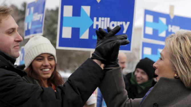 U.S. Democratic presidential candidate Hillary Clinton high-fives a supporter outside a polling place in Derry, New Hampshire February 9, 2016, the day of New Hampshire's first-in-the-nation primary.   REUTERS/Brian Snyder