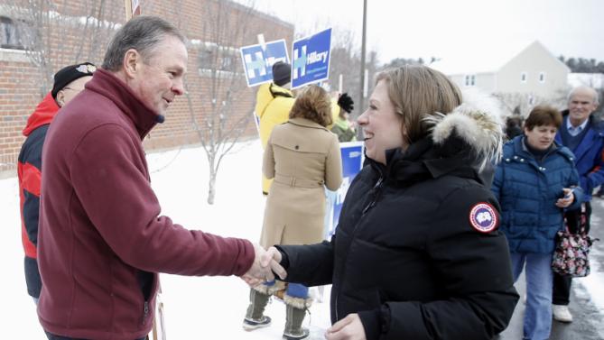 Frank Fiorina, husband of Republican presidential candidate Carly Fiorina shake hands with Chelsea Clinton, daughter of Democratic presidential candidate Hillary Clinton, as they campaign outside a polling place during the first-in-the-nation presidential primary, Tuesday, Feb. 9, 2016, in Derry, N.H. (AP Photo/Matt Rourke)
