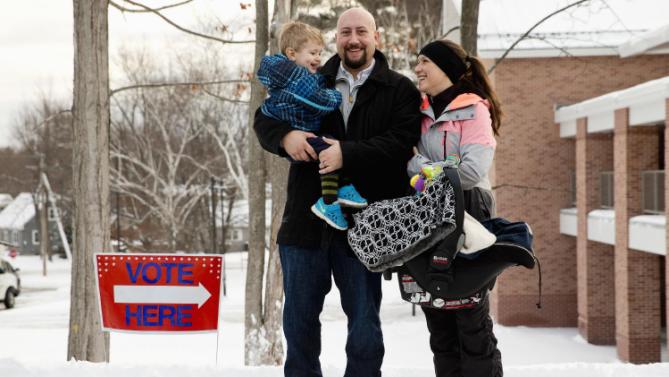 Andrew Stephens, left, and Kelly Stephens, of Nashua, N.H., hold their children Luke, 2, and Finn, five-months, as they pose for a portrait outside their polling place at Broad Street Elementary in Nashua, N.H., Tuesday, Feb. 9, 2016, during the New Hampshire primary. “We liked her the last time around,” Andrew Stephens, a psychotherapist, said of Democratic presidential candidate Hillary Clinton’s unsuccessful 2008 campaign. “And the Republican campaign is just a bit of a circus.” Kelly Stephens, an occupational therapist, agreed, “My heart wanted Bernie Sanders. My head said Hillary. She’s a little more put together. The thought process is a little more there.” (AP Photo/Jacquelyn Martin)