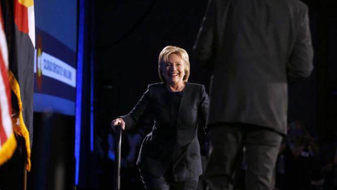 Democratic presidential candidate Hillary Clinton walks on stage to speak to guests at the Colorado Democrats 83rd Annual Dinner, in Denver, Saturday, Feb. 13, 2016. (AP Photo/Brennan Linsley)