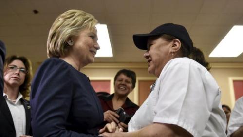 Democratic presidential candidate Hillary Clinton greets a worker at Harrah's Las Vegas in Las Vegas, Nevada February 13, 2016. REUTERS/David Becker