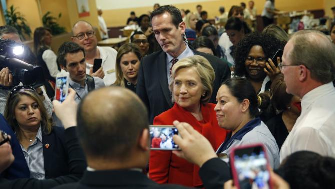 Democratic presidential candidate Hillary Clinton poses for pictures with employees of Caesars Palace during a visit to the casino Sunday, Feb. 14, 2016, in Las Vegas. (AP Photo/John Locher)