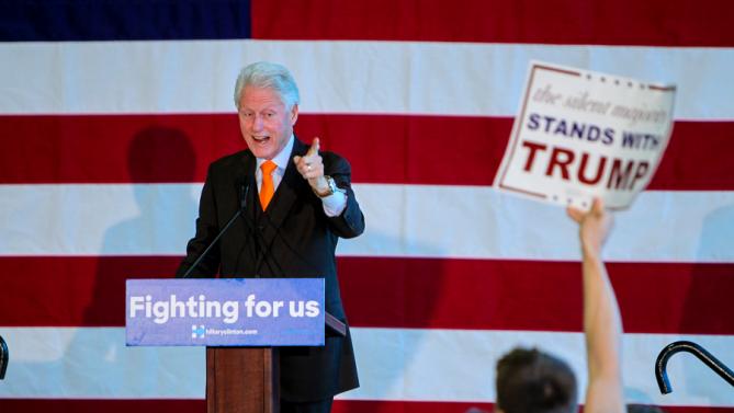 President Bill Clinton makes a point to a Donald Trump supporter, during a rally for Hillary Clinton. who is running for the Democratic presidential nomination, at the Port of Palm Beach in Riviera Beach, Fla., Monday, Feb. 15, 2016. (Richard Graulich/The Palm Beach Post via AP)