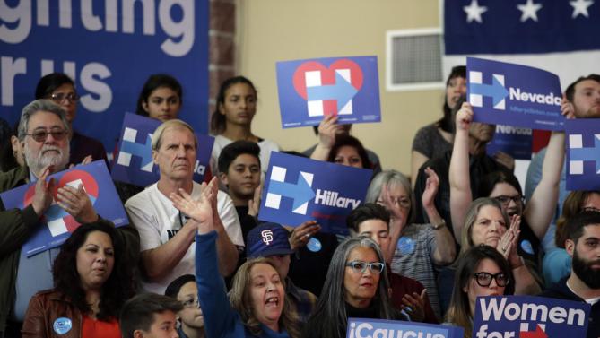 Supporters wave signs as Democratic presidential candidate Hillary Clinton speaks at a rally at Truckee Meadows Community College on Monday, Feb. 15, 2016, in Reno, Nev. (AP Photo/Marcio Jose Sanchez)