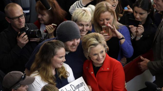 Democratic presidential candidate Hillary Clinton, in red, poses for photos with supporters after speaking at a rally at Truckee Meadows Community College on Monday, Feb. 15, 2016, in Reno, Nev. (AP Photo/Marcio Jose Sanchez)