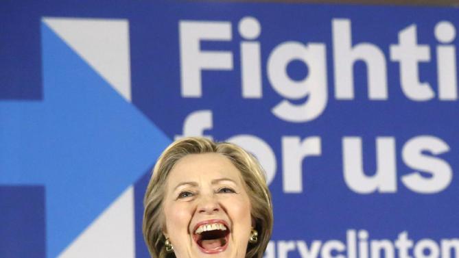 Democratic presidential candidate Hillary Clinton, laughs during an introductory poem by Geneva Reed-Veal, the mother of Sandra Bland, who was found dead in a Texas jail cell, Wednesday, Feb. 17, 2016, during a campaign stop in Chicago. (AP Photo/Charles Rex Arbogast)