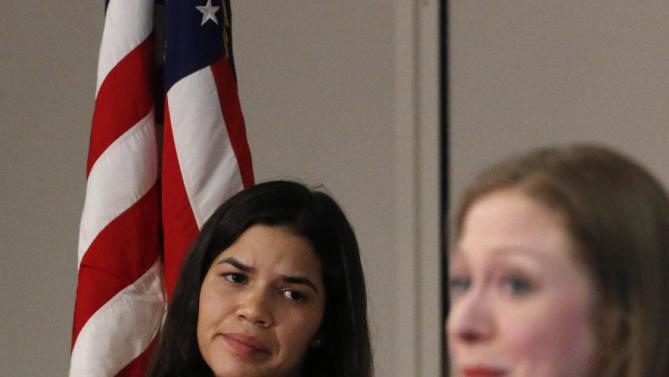 Actress America Ferrera, left, listens as Chelsea Clinton speaks to students during a campaign stop on behalf of her mother, Democratic presidential candidate Hillary Clinton, at The University of Denver, Thursday, Feb. 18, 2016. (AP Photo/Brennan Linsley)