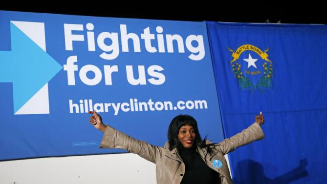 A woman poses for a photo in front of a sign after a rally with Democratic presidential candidate Hillary Clinton, Thursday, Feb. 18, 2016, in Las Vegas. (AP Photo/John Locher)