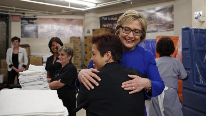 Democratic presidential candidate Hillary Clinton, in blue, hugs Caesars Palace employee Miriam Deleon during a visit to the hotel and casino Thursday, Feb. 18, 2016, in Las Vegas. (AP Photo/John Locher)