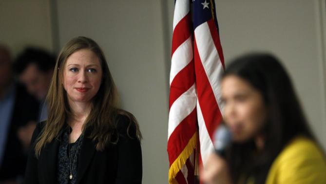 Chelsea Clinton, left, listens as actress America Ferrera introduces her during a campaign stop on behalf of Clinton's mother, Democratic presidential candidate Hillary Clinton, at The University of Denver, Thursday, Feb. 18, 2016, in Denver. (AP Photo/Brennan Linsley)