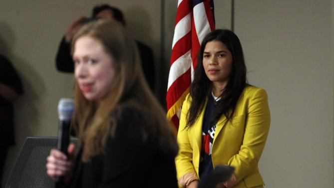 Actress America Ferrera, left, listens as Chelsea Clinton speaks to students during a campaign stop on behalf of Clinton's mother, Democratic presidential candidate Hillary Clinton, at The University of Denver, Thursday, Feb. 18, 2016, in Denver. (AP Photo/Brennan Linsley)