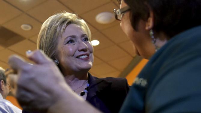 U.S. Democratic presidential candidate Hillary Clinton greets a worker in the employee dinning room at the Rio Hotel and Casino in Las Vegas, Nevada February 18, 2016. REUTERS/David Becker