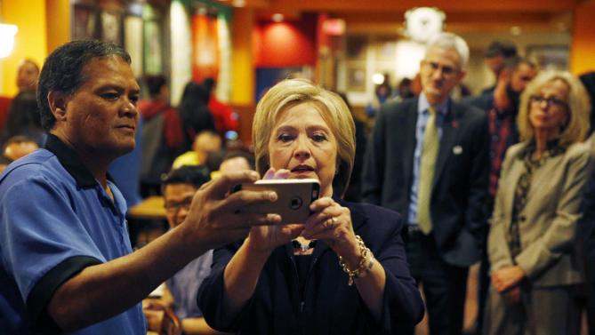 Democratic presidential candidate Hillary Clinton takes a selfie with an employee of the Rio during a visit to the hotel and casino Thursday, Feb. 18, 2016, in Las Vegas. (AP Photo/John Locher)