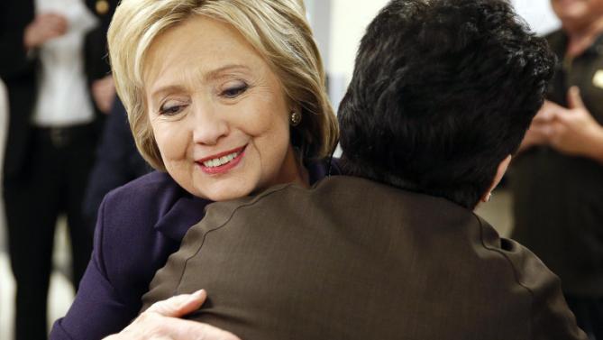 Democratic presidential candidate Hillary Clinton hugs an employee of Paris Las Vegas during a visit to the hotel and casino Thursday, Feb. 18, 2016, in Las Vegas. (AP Photo/John Locher)