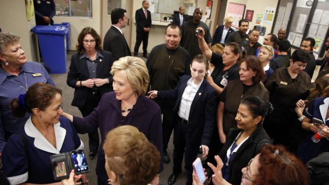 Democratic presidential candidate Hillary Clinton, second from left, meets with employees of Paris Las Vegas during a visit to the hotel and casino Thursday, Feb. 18, 2016, in Las Vegas. (AP Photo/John Locher)