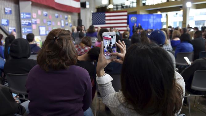 A supporter snaps a photo as U.S. Democratic presidential candidate Hillary Clinton speaks during a roundtable at the College of Southern Nevada in North Las Vegas, Nevada February 19, 2016. REUTERS/David Becker